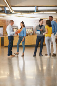 Discussion, lobby and business people in office with teamwork for creative project research. Conversation, group and magazine editors with collaboration for briefing on publishing in workplace